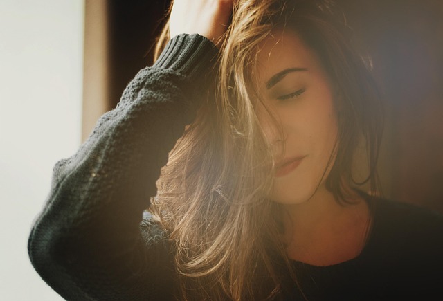 Girl touching her hair during stress, representing hair pulling behavior.